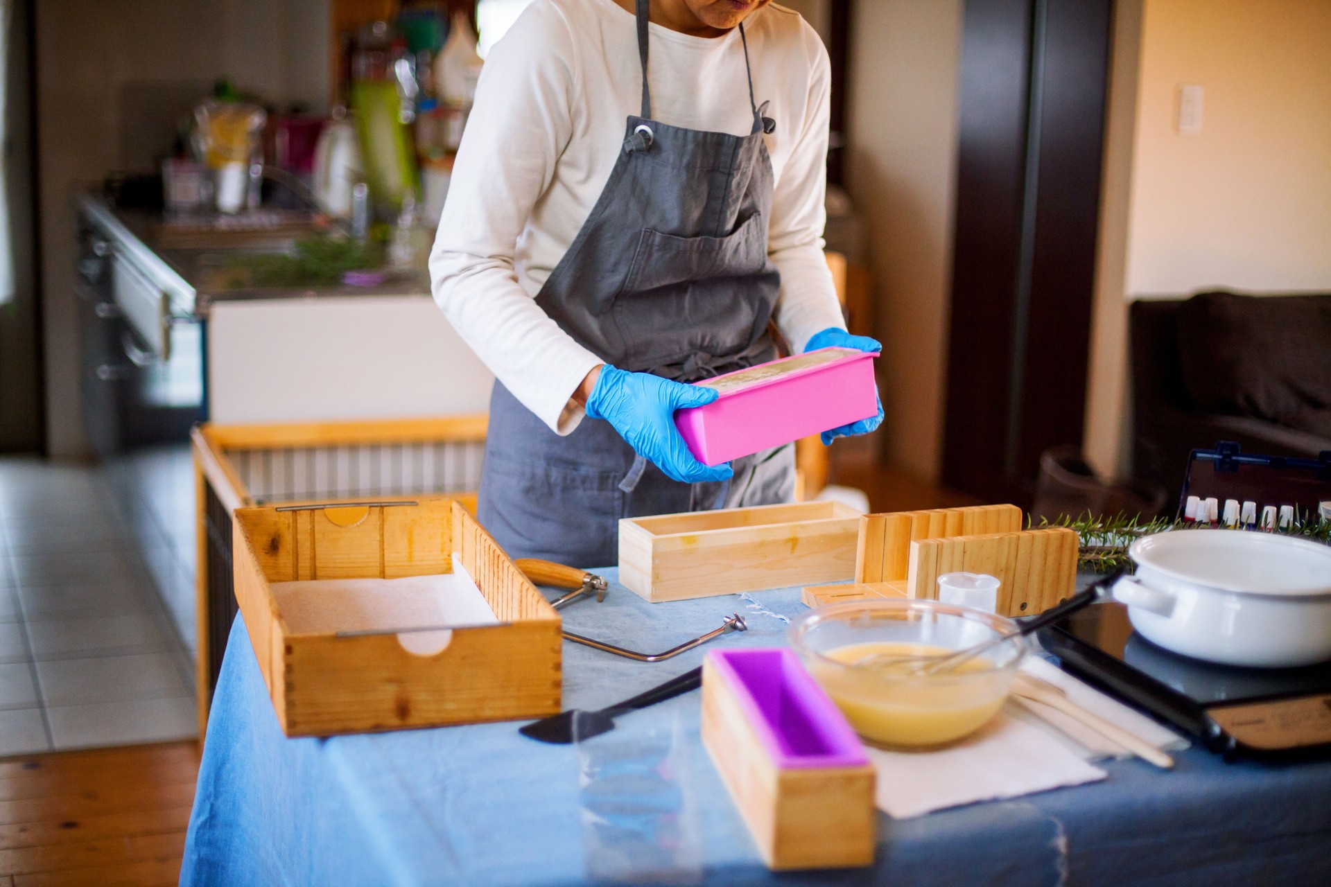 A woman making organic soap at home